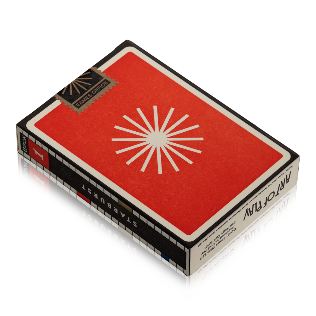 Closeup of an Eames Playing Card box showing a red background with white starburst design. The side of the box shows "Edition 1" and "Starburst".