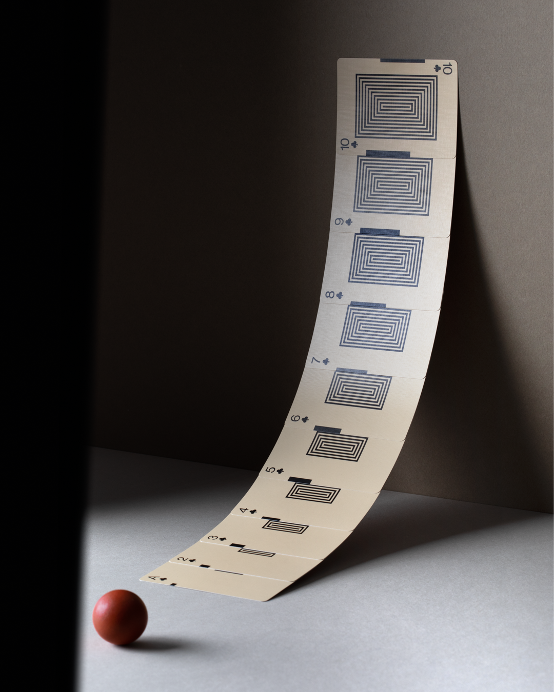 Unique playing cards in the suit of spades fanned out to show their design.