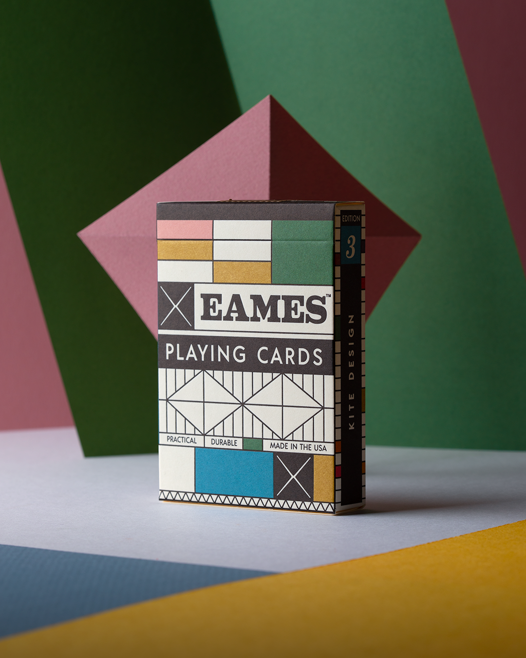 Eames Playing Cards box sitting upright on a table with a colorful colorblock design.