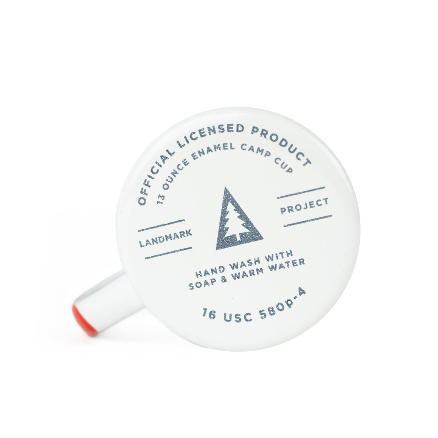 Image showing bottom of an enamel cup with details printed on it. Officially licensed product. 13 ounce enamel camp cup. Landmark Project with tree emblem inside a shaded triangle. Hand wash with soap & warm water.